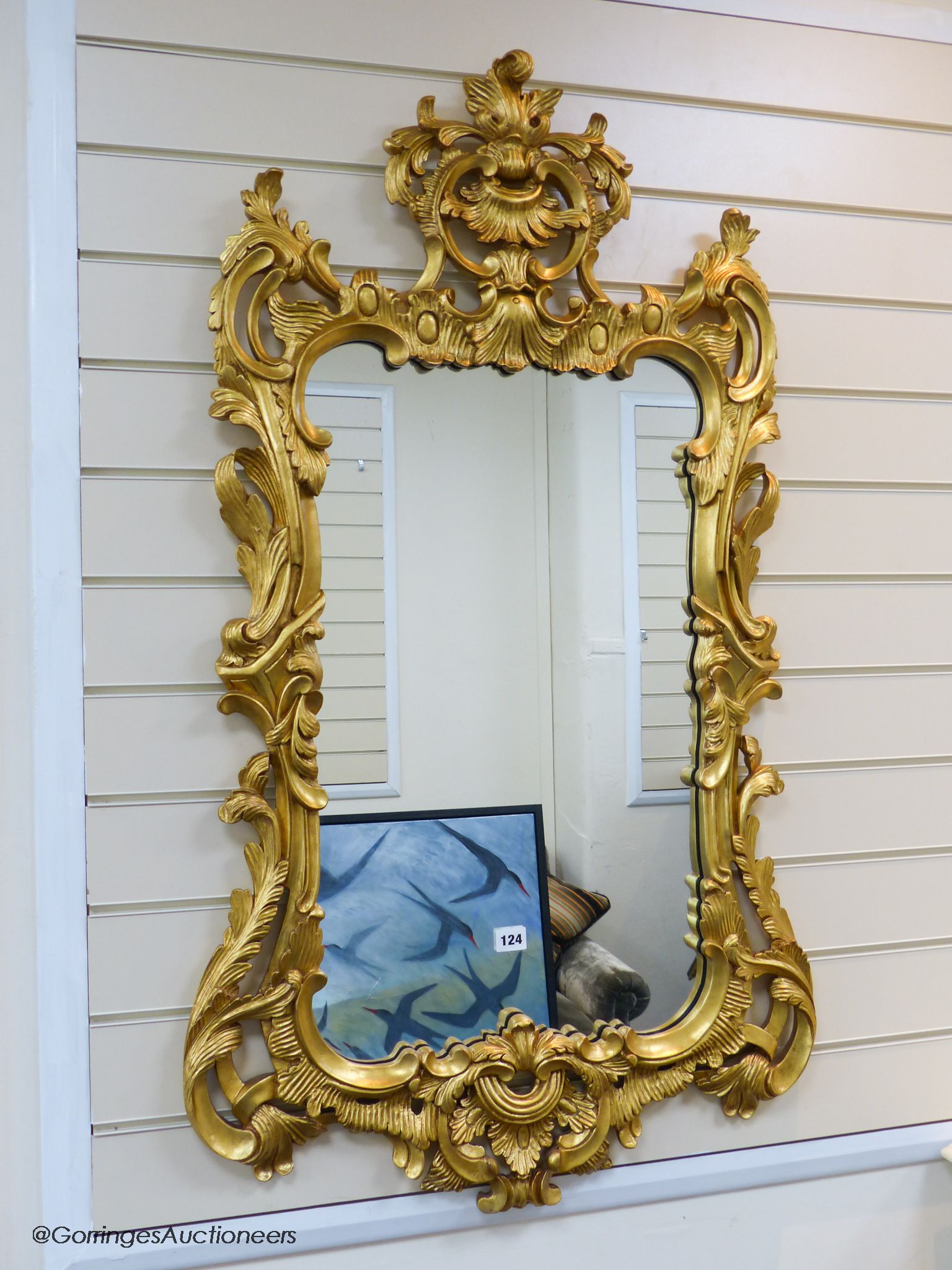 A 19th century rococo revival giltwood console table, 95cm wide, 86.5cm high and a similar later giltwood mirror, 113cm high, 64.5cm wide